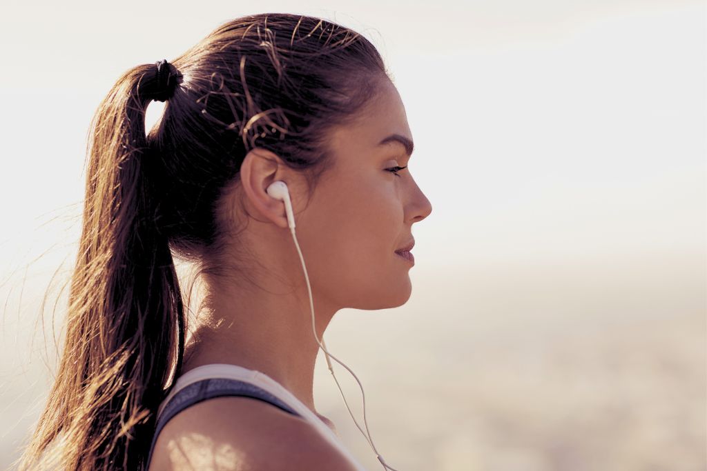 a woman casually hearing music while running