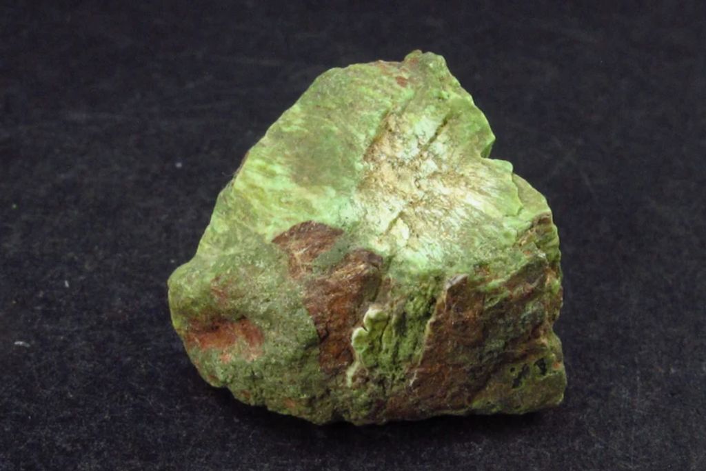 Gaspeite Crystal on a black granite. Source: EtsyCA | TheGlobalStone