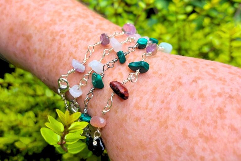 woman wearing 4 gemstone bracelet at the same time