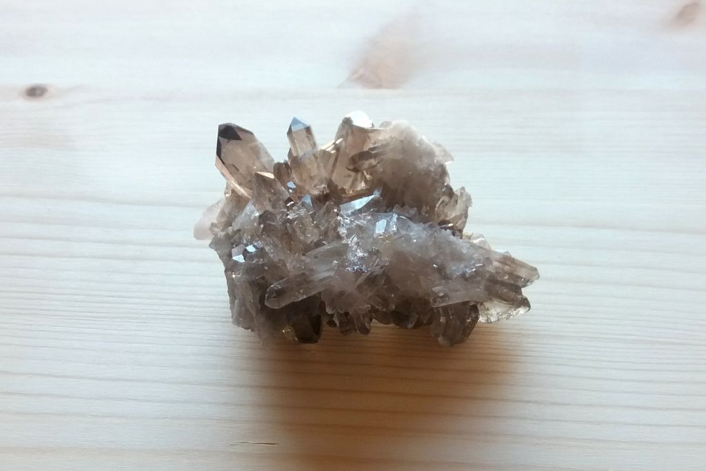 Gray Smoky Quartz on a wooden background