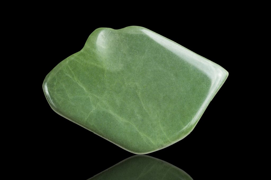 Green Jasper Crystal on a black reflective background