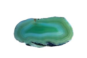 A slice of a green agate crystal on a white background