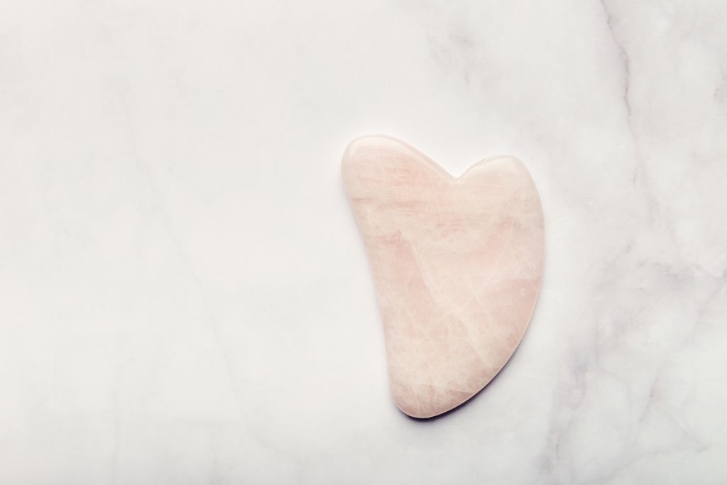 Gua Sha Stone with a marble-like background.