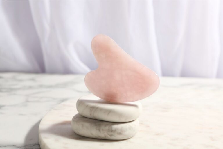 A Gua Sha stone on top of piled stones