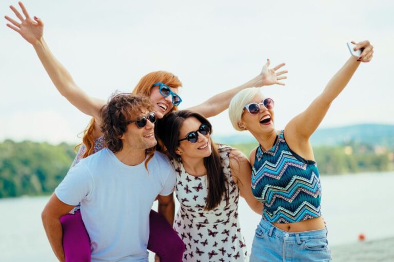 A group of happy people is taking a group selfie during their vacation.