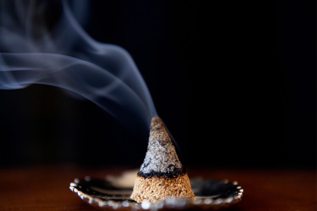a burning Incense cone placed on a dish