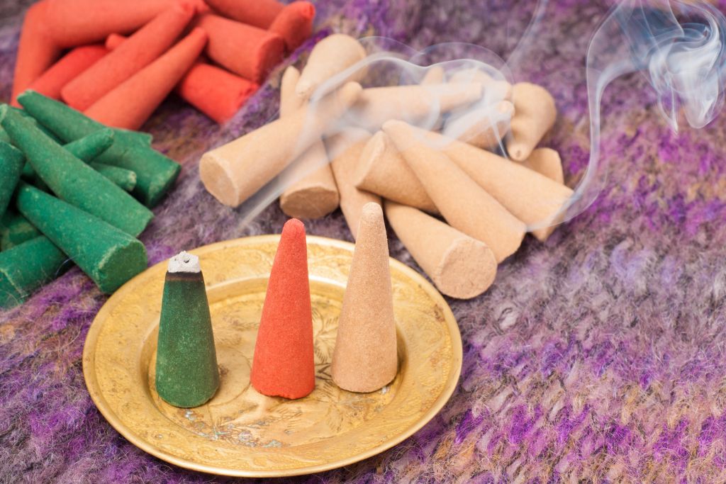 burning incense cones in different colors