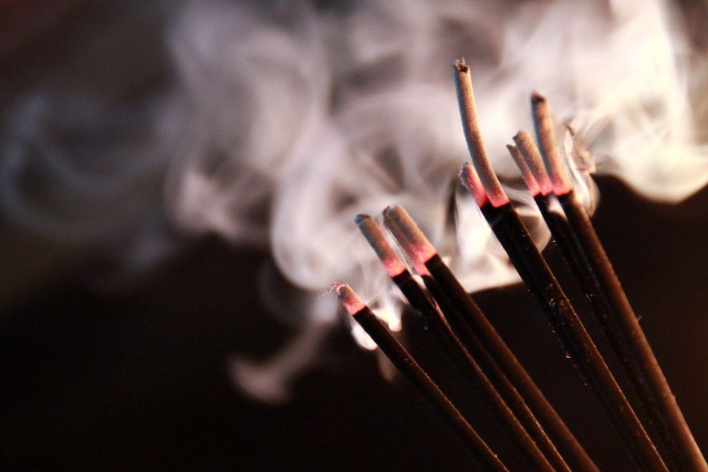 An incense that is burning on a dark background