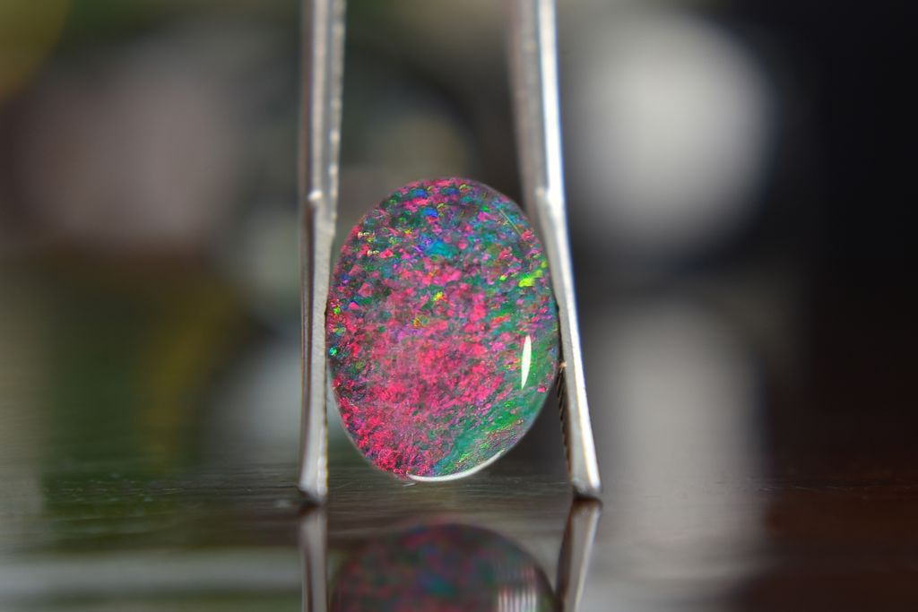 Opal stone in between a forceps