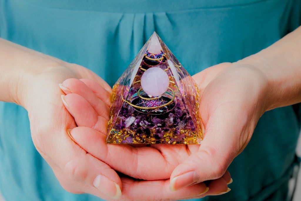 Orgone pyramid placed on a woman's palm