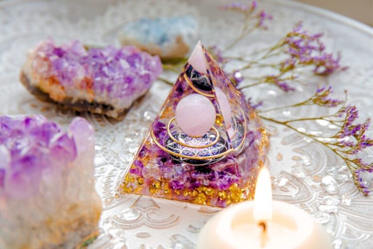 Orgone Pyramid surrounded by purple Amethyst and purple flowers