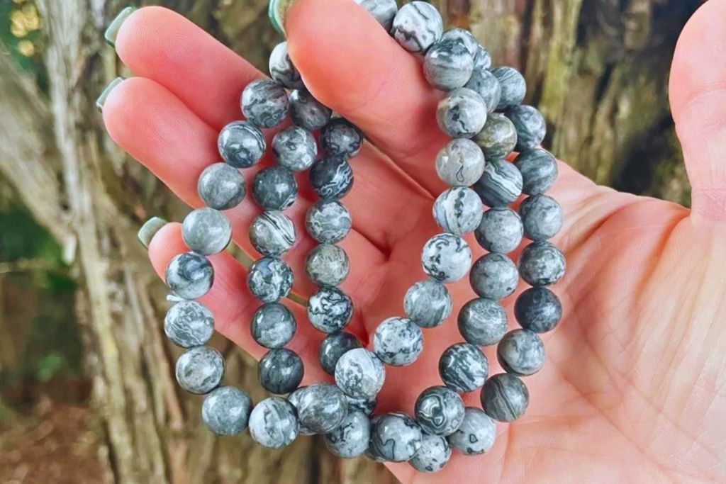 woman holding three bracelets of Picasso Jasper crystal. Image Source: Etsy | SoulSpiritCrystals:Julie