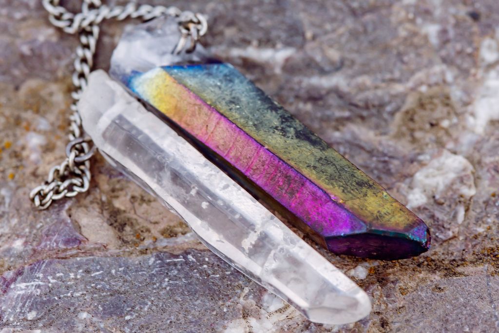 A quartz crystal necklace on the rock