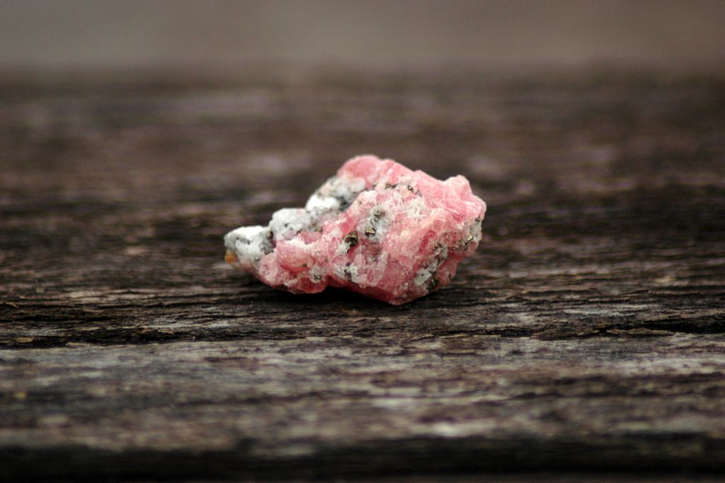 Rhodochrosite on a wooden background