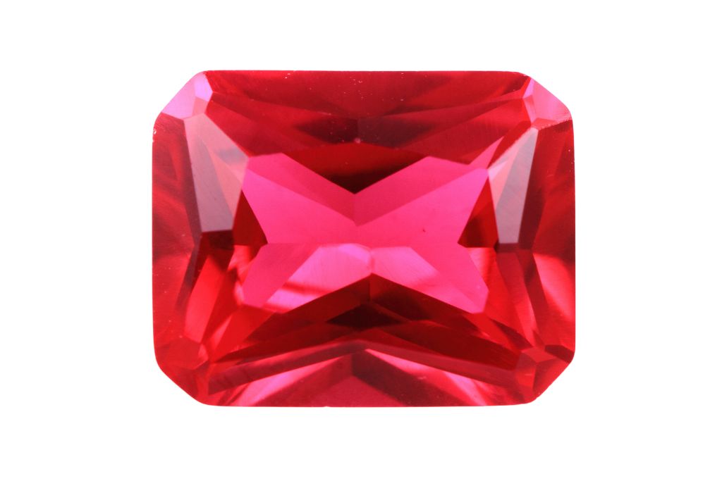 A polished Ruby crystal on a white background