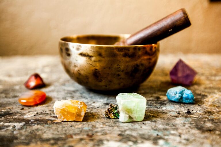 A singing bowl surrounded by different crystals.