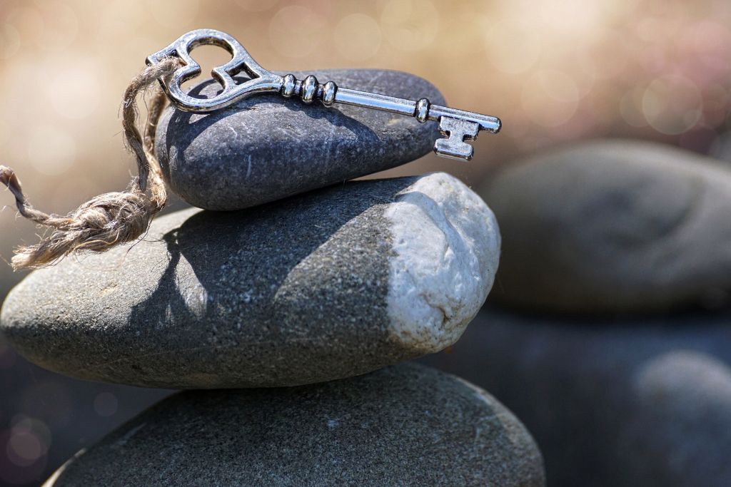 Stacked stones with a key on top