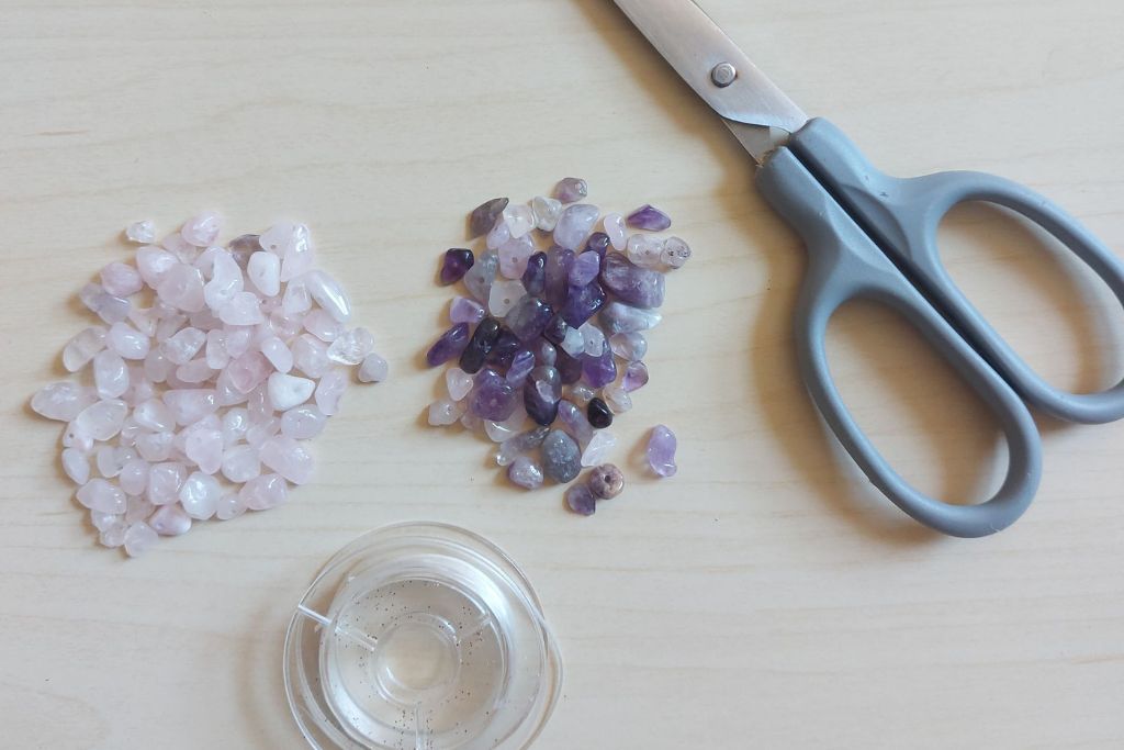 scissors, beads and, thread on the table