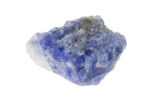 A raw tanzanite crystal on a white background