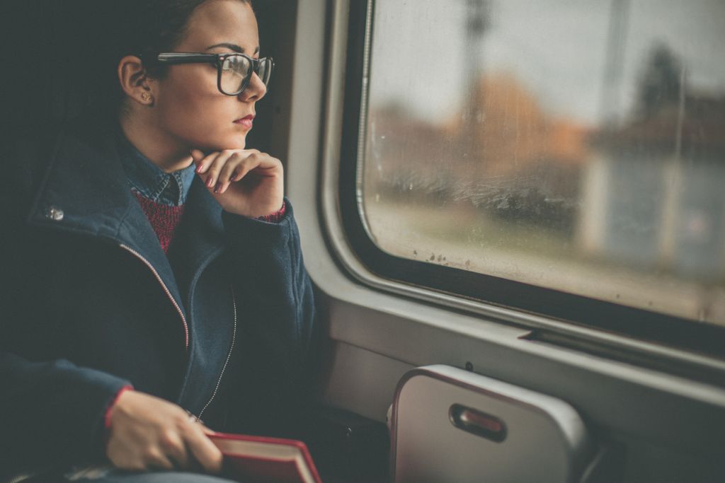 A woman is looking out from the window