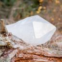 a white quartz crystal on a wood