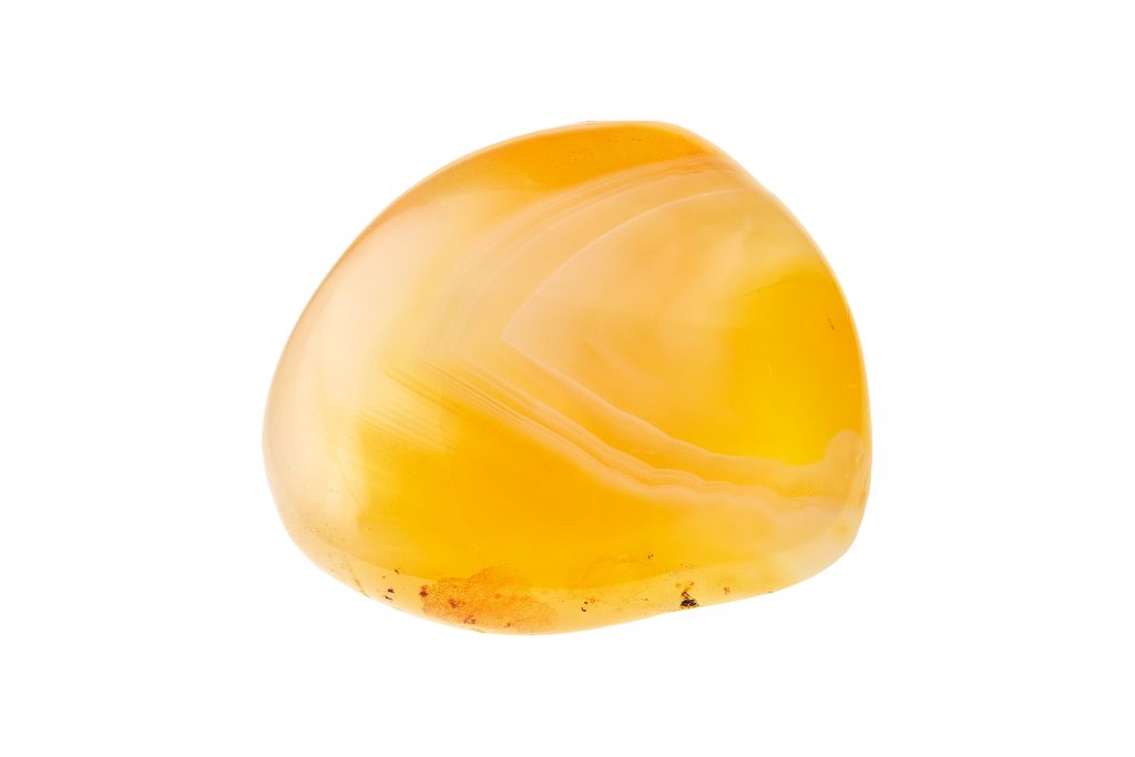 Yellow carnelian crystal on a white background