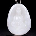 A white jade pendant on a dark background