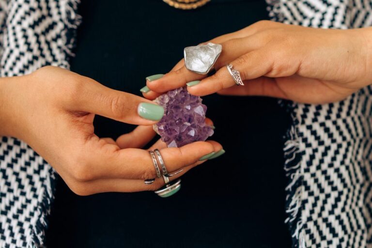 woman holding amethyst crystal
