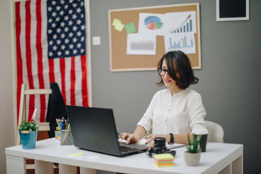 a successful woman looking towards her laptop while sitting