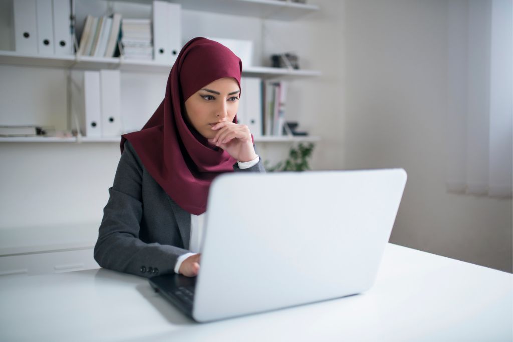 a woman using her laptop to do work