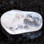 clear quartz on black background or rocks