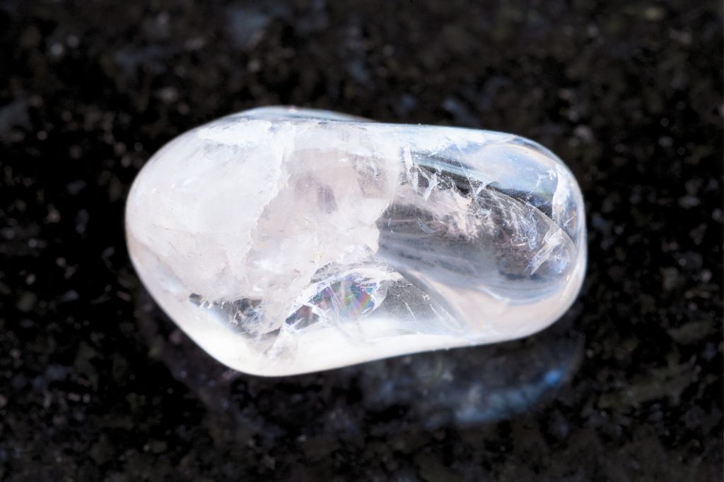 clear quartz on black background or rocks