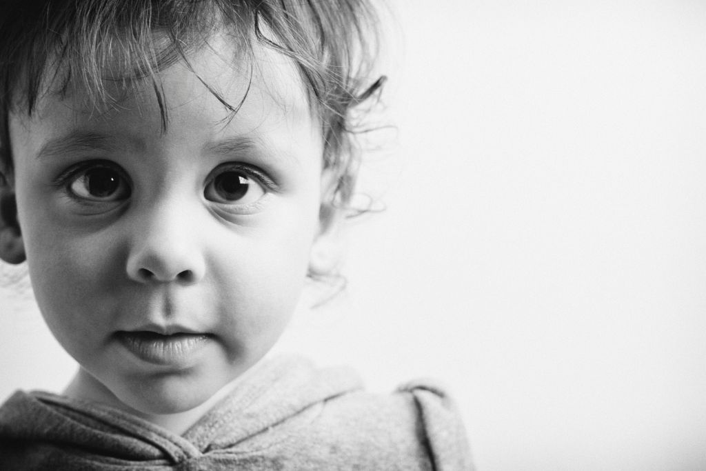 close up shot of a young female depicting innoncence with grayscale color grade