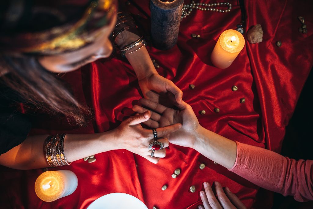 A Fortune teller reading the palm of a person