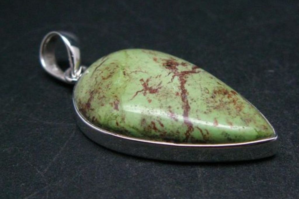 gaspeite pendant on rough platform. Source: EtsyCA | TheGlobalStone