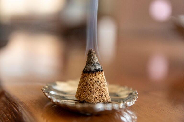 burning incense cone placed on a small dish