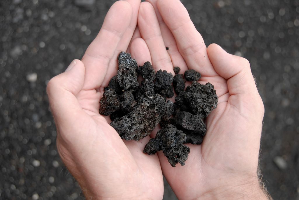 lava rock at the palm of models hand