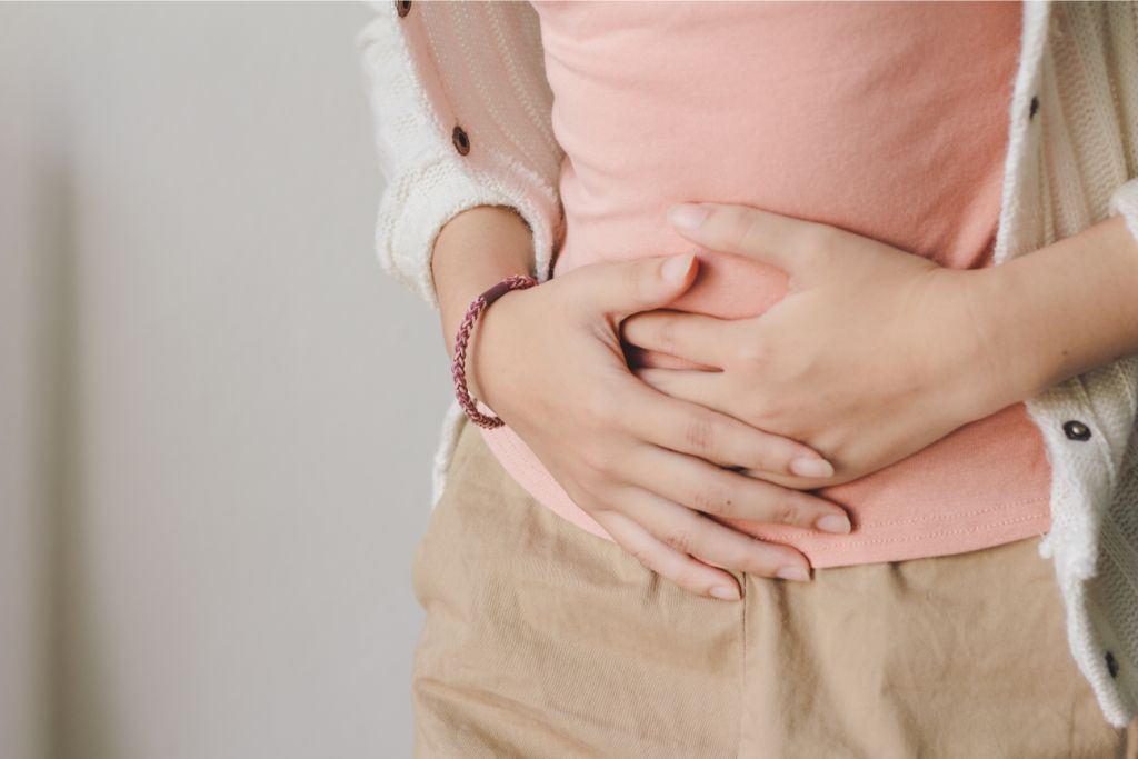 A woman touching her lower abdomen