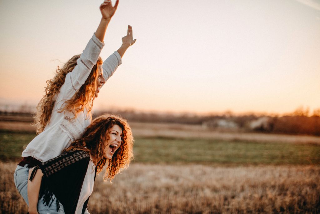 two ladies feeling happy and expressing positive energies