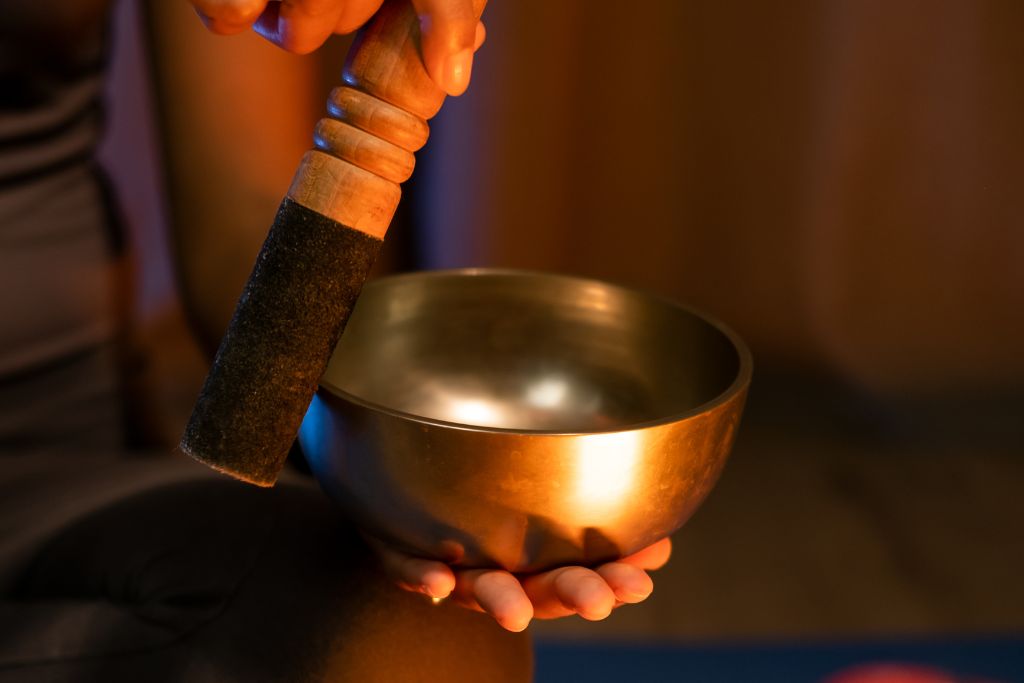 woman performing a ritual using singing bowl