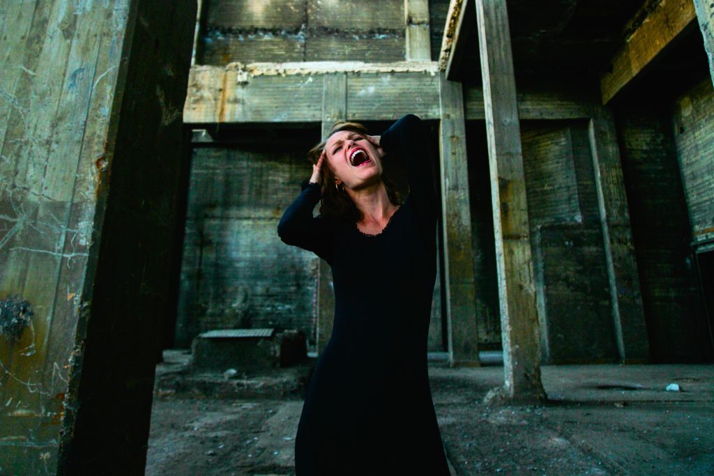 woman wearing black dress screaming