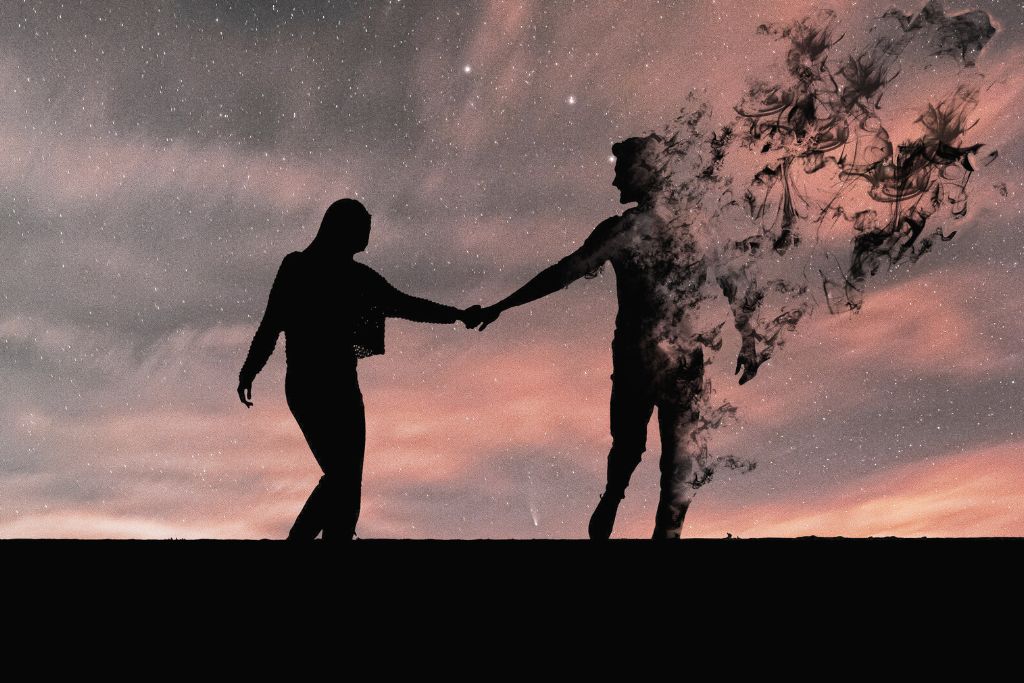 Silhouette of a couple in black with the man's figure vanishing as smoke.