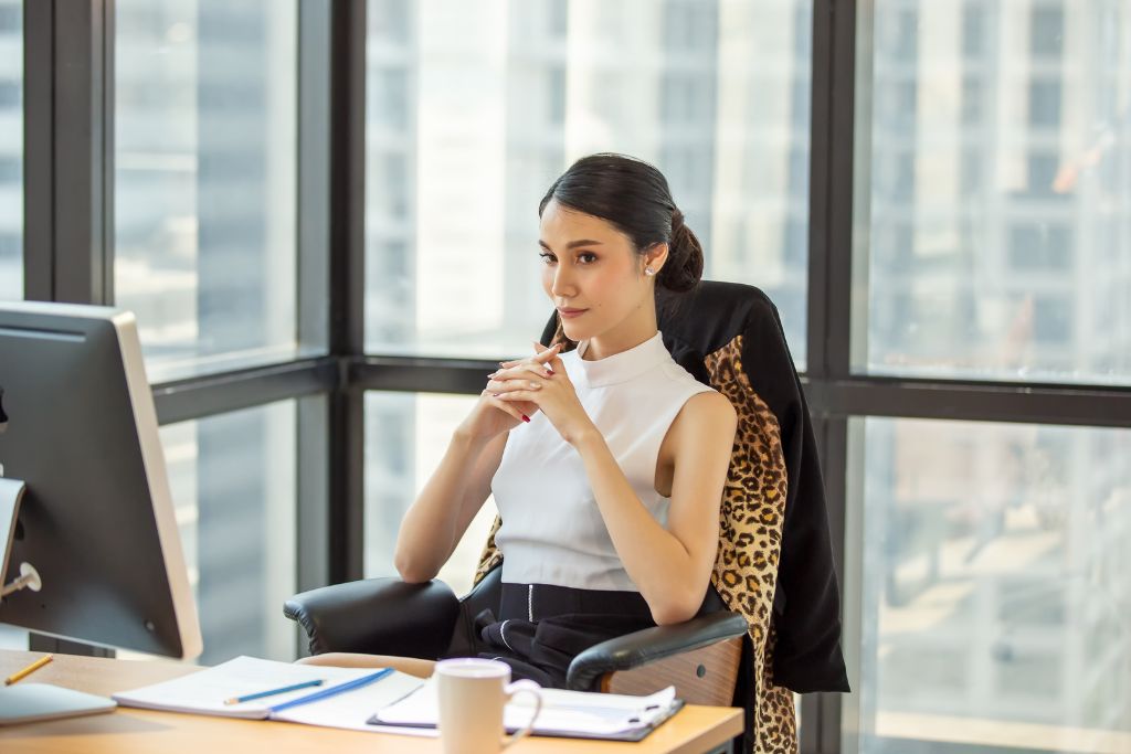 A female boss sitting on the chair
