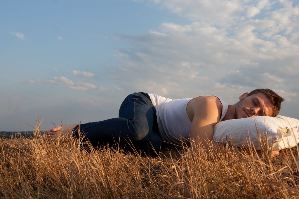 A man is sleeping on the fields