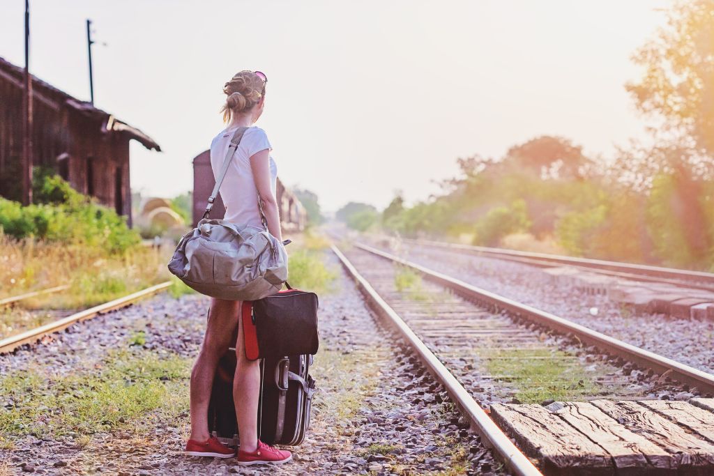 A woman is waiting for the train to arrive