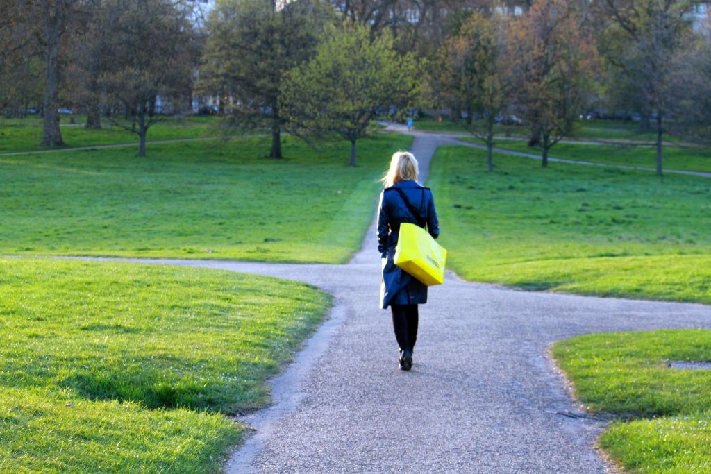 A woman is walking on the road