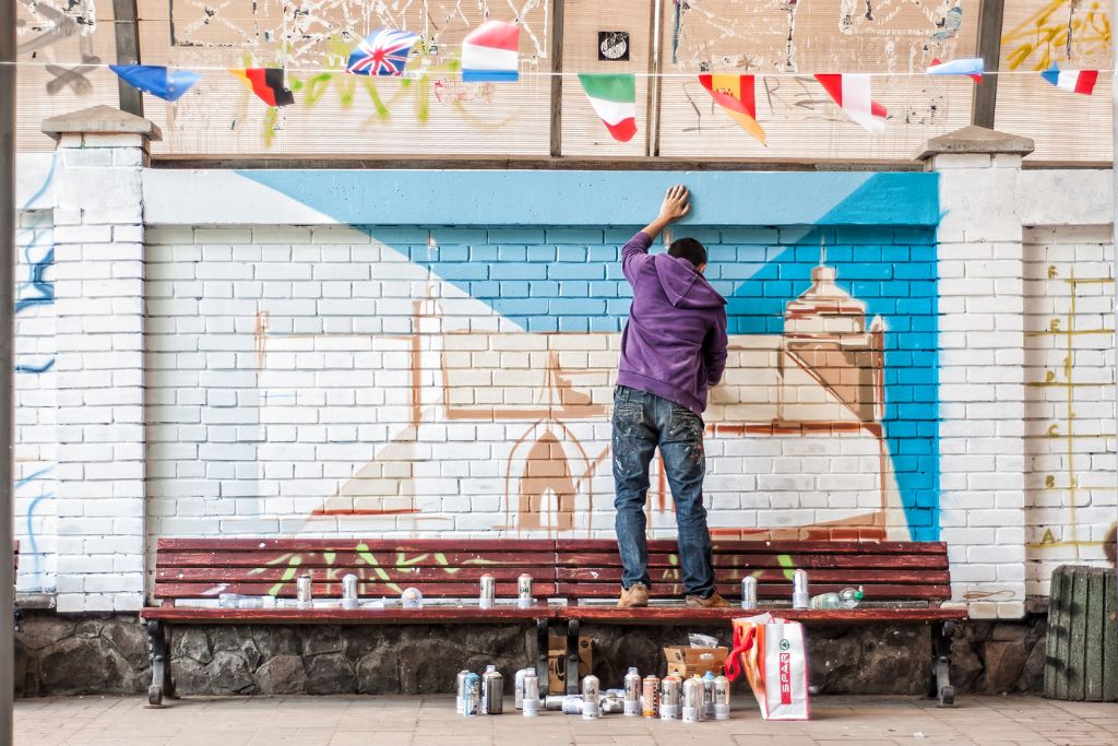 An artist is painting the wall