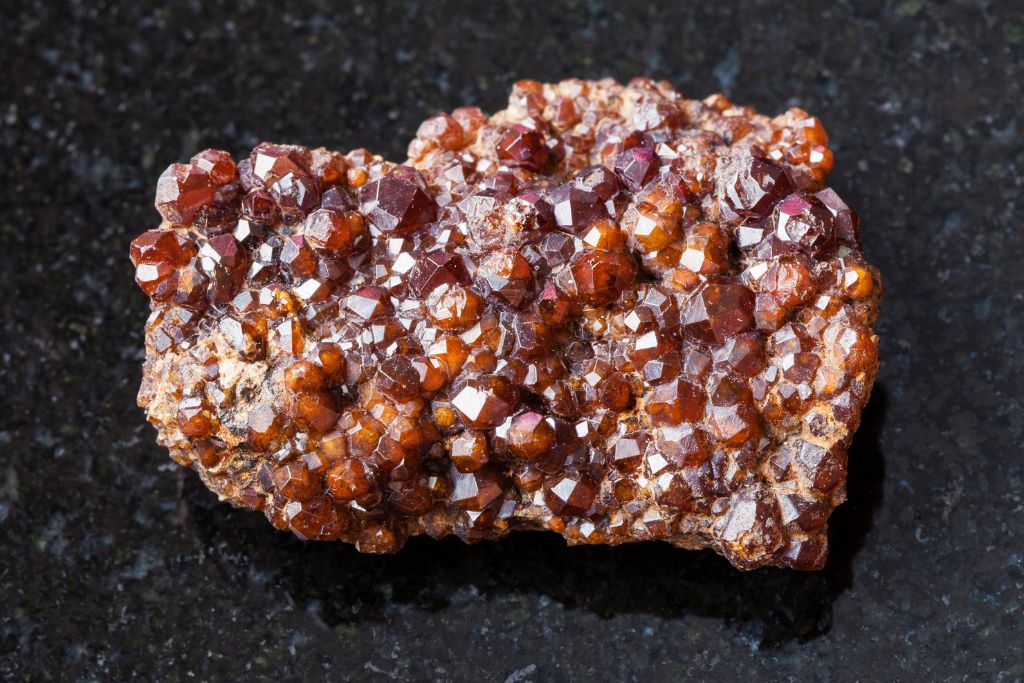 Andradite Garnet (Melanite) on a black granite