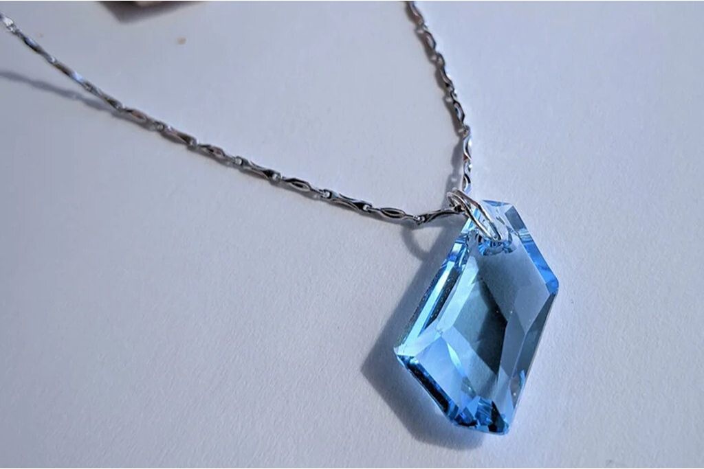 an Aqua Swarovski crystal pendant on a silver chain necklace