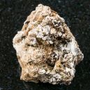 An Astrophyllite crystal on a black granite